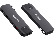 Charger l&#39;image dans la galerie, Deux appareils rectangulaires gris foncé avec plusieurs ports sur une surface noire, inclinés.
