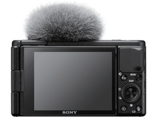 Charger l&#39;image dans la galerie, Un appareil photo noir avec un microphone attaché, avec un écran à l&#39;arrière.
