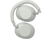 Charger l&#39;image dans la galerie, Vue de dessus du casque Sony gris clair, plié. Les écouteurs sont orientés vers le haut.
