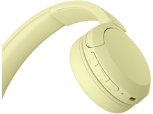 Charger l&#39;image dans la galerie, Gros plan d&#39;un casque jaune. Le casque possède des boutons de volume et d&#39;alimentation. Le design est élégant.
