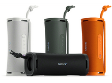 Charger l&#39;image dans la galerie, Quatre enceintes Sony colorées ; blanc, vert, orange et noir, disposées sur une surface blanche.
