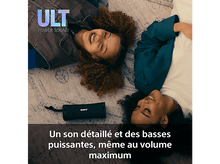 Charger l&#39;image dans la galerie, Deux femmes souriantes, allongées sur un tapis. Enceinte Sony au centre. Enceinte noire.
