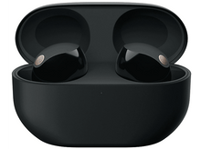 Charger l&#39;image dans la galerie, Écouteurs sans fil noirs dans un étui de chargement, ouverts sur une surface blanche.
