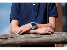 Charger l&#39;image dans la galerie, Poignet d&#39;une personne portant une smartwatch blanche, bras croisés.
