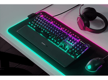 Charger l&#39;image dans la galerie, Une configuration de jeu avec un clavier, une souris, un casque et un tapis avec éclairage RVB.
