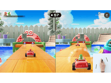 Charger l'image dans la galerie, Vue écran partagé d'un jeu style Mario Kart avec des voitures rouges sur une piste en bois près d'une piscine.
