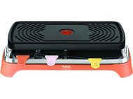 Un appareil à raclette avec un dessus noir et une base orange, avec des poignées roses, jaunes et rouges.