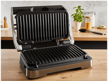 Charger l&#39;image dans la galerie, Un grill noir ouvert avec une base en acier inoxydable, posé sur une surface en bois.
