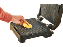 Charger l&#39;image dans la galerie, Une personne nettoyant un grill avec une éponge jaune, isolé sur noir.
