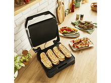 Charger l&#39;image dans la galerie, Gril noir ouvert avec des sandwichs grillés et divers aliments grillés sur des assiettes sur une surface en bois.
