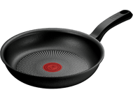 Poêle noire avec cercle rouge au milieu.