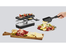 Charger l&#39;image dans la galerie, Gril à raclette avec de la nourriture. Une assiette avec de la salade, de la viande et du fromage. Planche en bois avec de la viande et du fromage.
