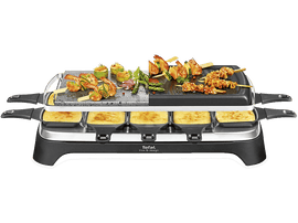 Un appareil à raclette avec une pierre et une surface de grill, plus quatre poêles à fromage en dessous.