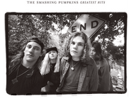 Photo en noir et blanc. Le groupe The Smashing Pumpkins, avec un panneau « END ».
