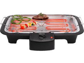 Gril électrique avec de la nourriture. Steak, poivrons verts et rouges sur une surface chaude.