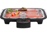 Gril électrique avec de la nourriture. Steak, poivrons verts et rouges sur une surface chaude.