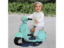 Charger l&#39;image dans la galerie, Un bébé sur une trottinette jouet bleu clair. Le bébé sourit et regarde la caméra.
