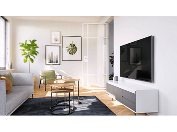 Salon avec canapé gris, art, télévision et petites tables rondes.