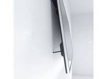 Charger l&#39;image dans la galerie, Un téléviseur monté sur un mur blanc. Le téléviseur est incliné et l&#39;écran est noir.
