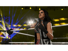 Charger l&#39;image dans la galerie, Une lutteuse regardant en l&#39;air, appuyée contre les cordes dans un ring de catch.
