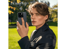 Charger l&#39;image dans la galerie, Homme tenant un téléphone gris ZTE Blade A55, dans un parc, en costume.
